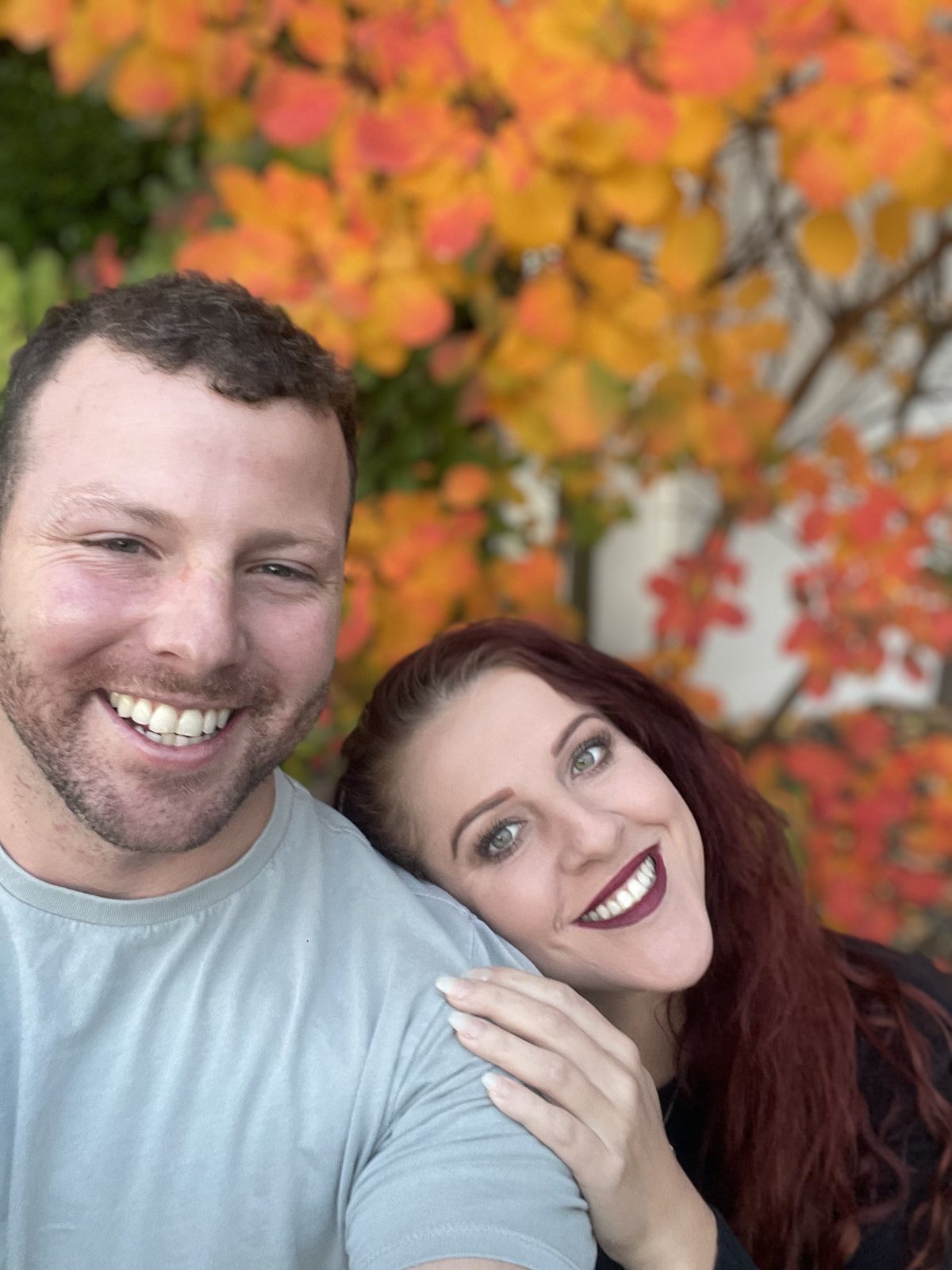 Alex and Dani together under bright autumn foliage